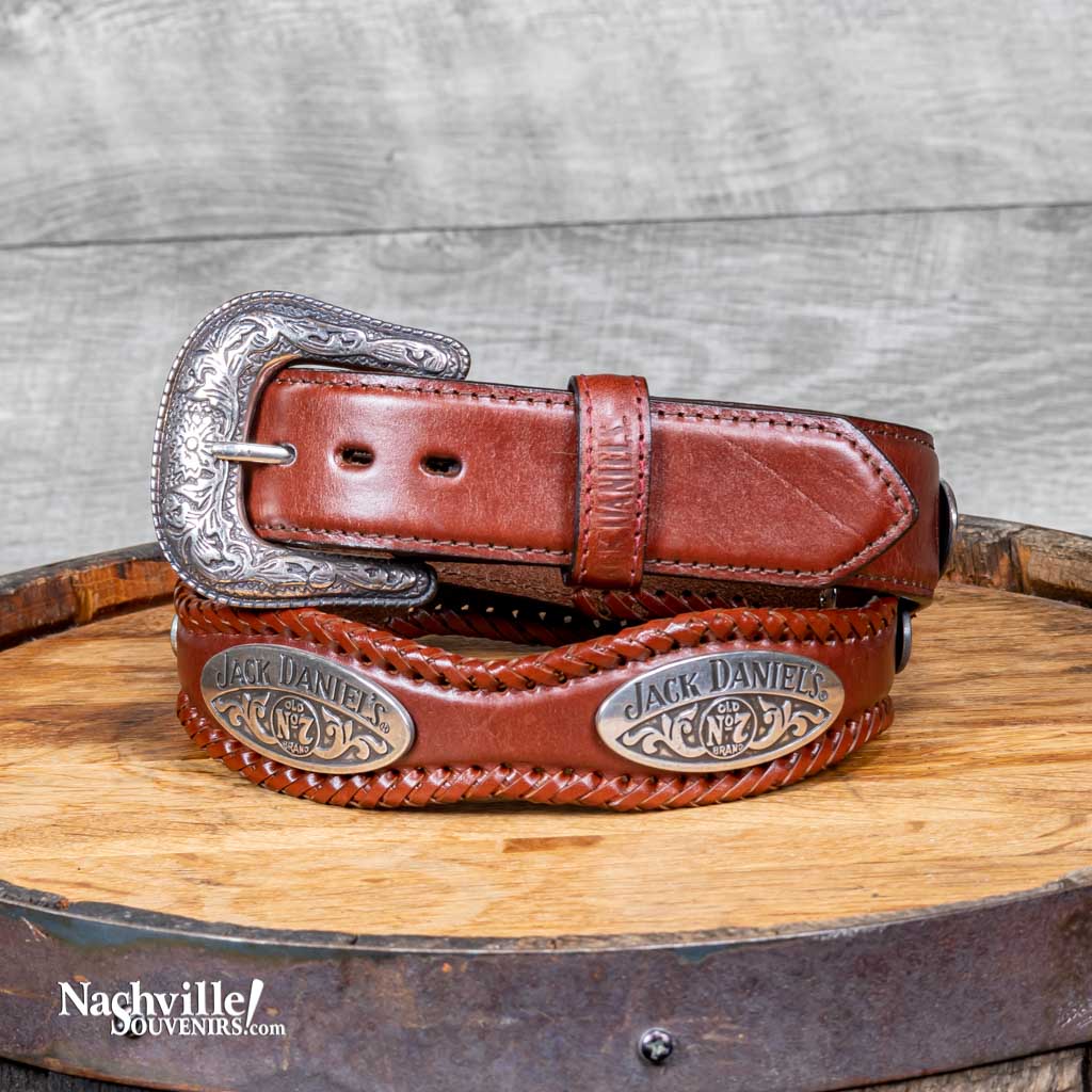Officially licensed Jack Daniels Scalloped Belt with JD Conchos is a scalloped leather belt with hand laced edges.  This JD belt features a silver plated buckle and exclusive Jack Daniel's branded conchos around the full width of the belt. 