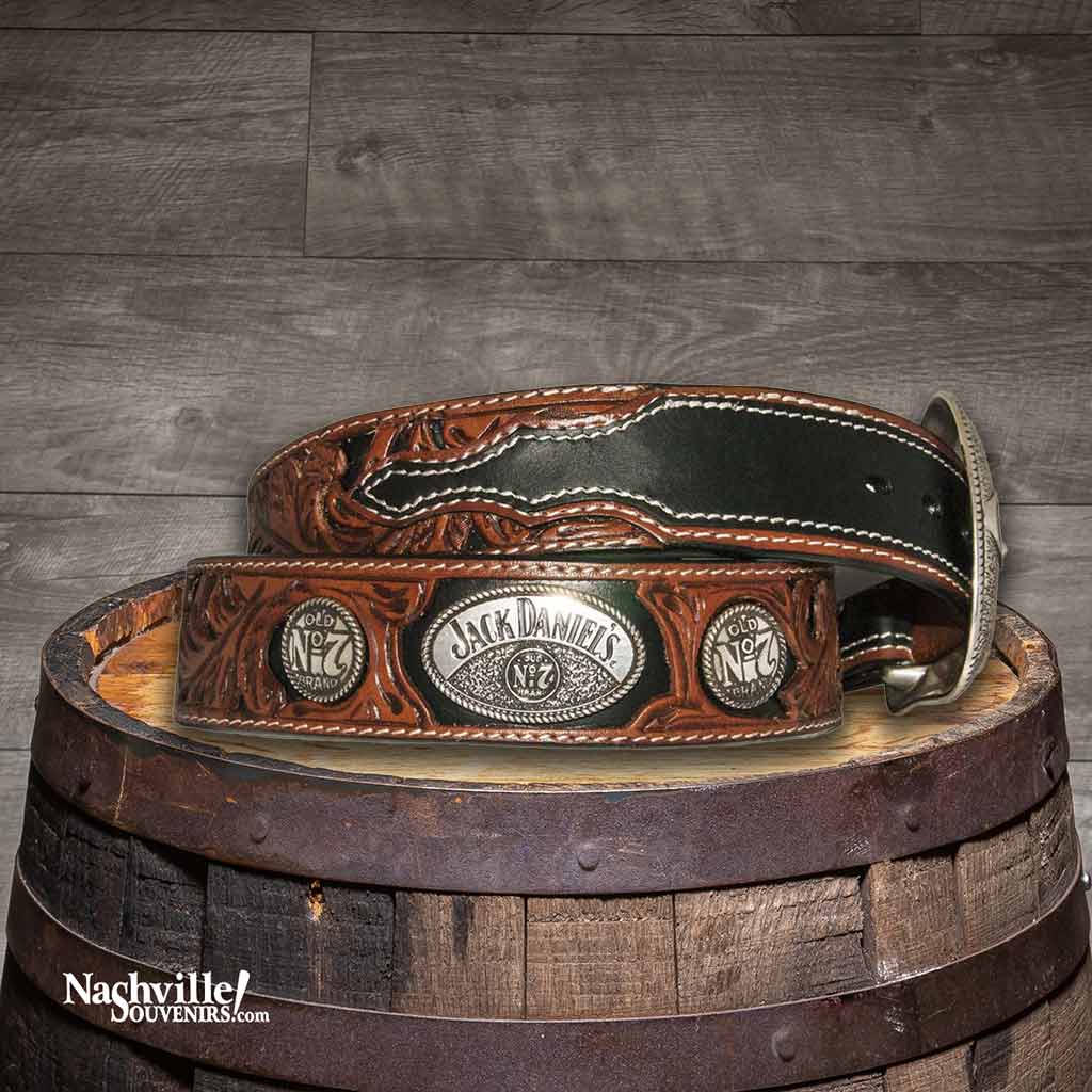 Hip view of a Jack Daniel's Black and Brown Layered Belt with hand tooled features along with Jack Daniel's buckle and conchos.