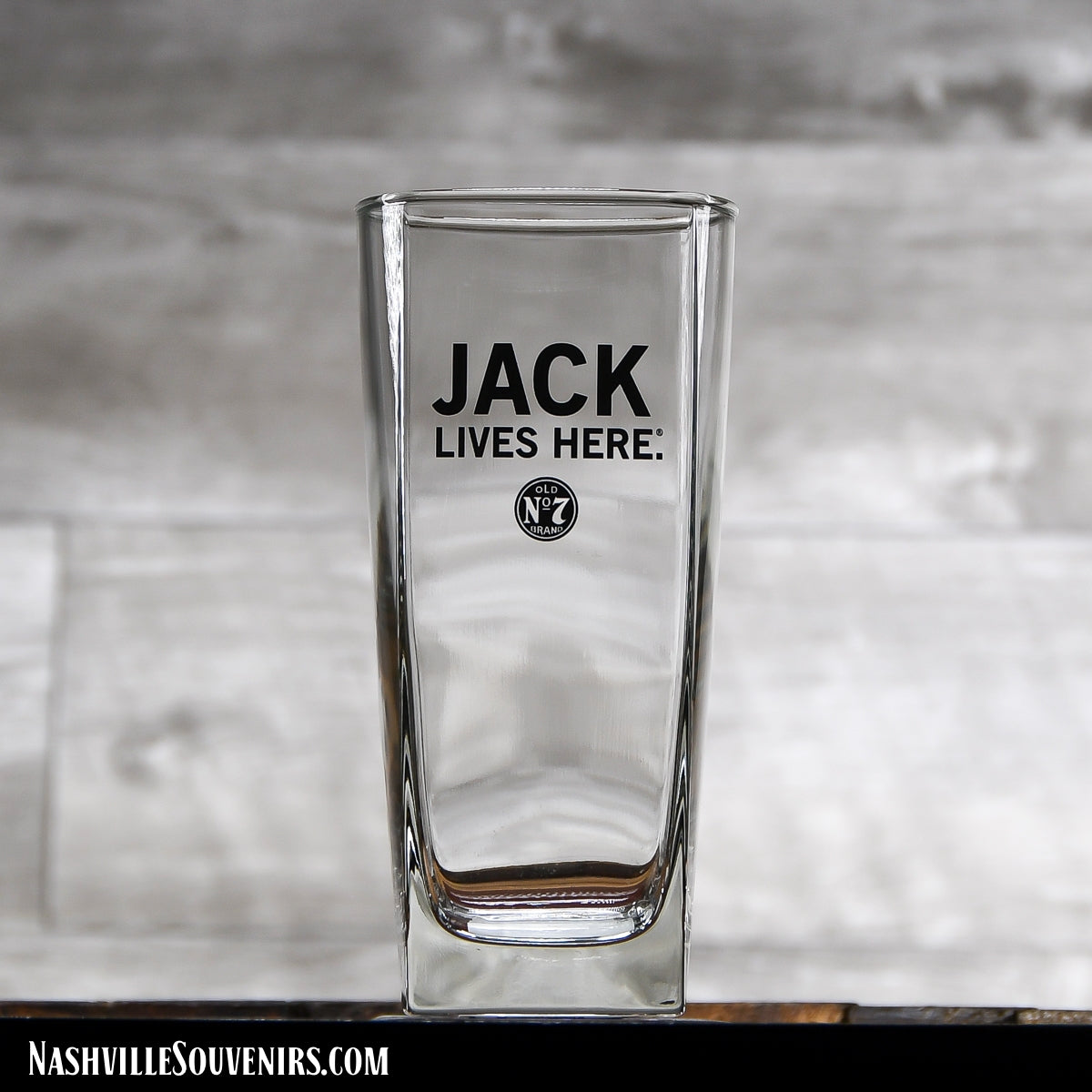 This officially licensed Jack Daniels "Jack Lives Here" Tall Rocks glass. It features "Jack Lives Here" in bold black letters with a small Old No.7 Brand circular logo below. Get yours today with FREE SHIPPING on all US orders over $75!
