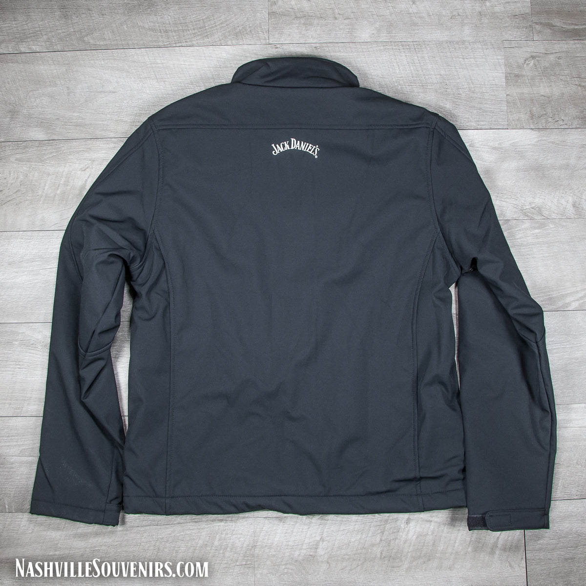 Back side of an officially licensed Jack Daniels Zip Soft Shell Black Jacket is made of soft shell polyester with a zip-up front. Has Jack Daniels Swing and Bug embroidered logo on the front left chest. Get yours today with FREE SHIPPING on all US orders over $75!