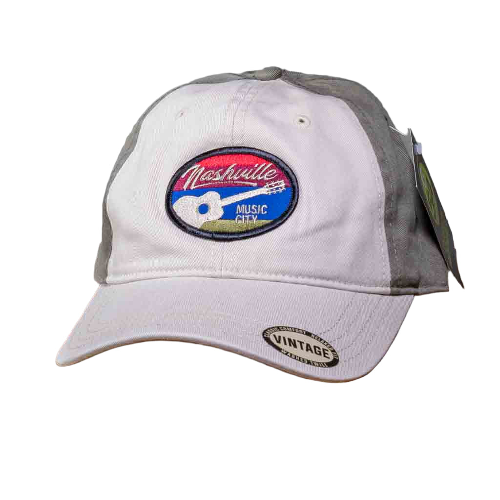 This Nashville Music City Cap features an oval patch with an embroidered Guitar and Nashville Music City stitched on a colored background. The Nashville hat has a stiff, rounded khaki colored bill in a relaxed fit vintage washed twill and a cloth front crown. The body has two matching front khaki panels and the remainder are in a darker olive green color.