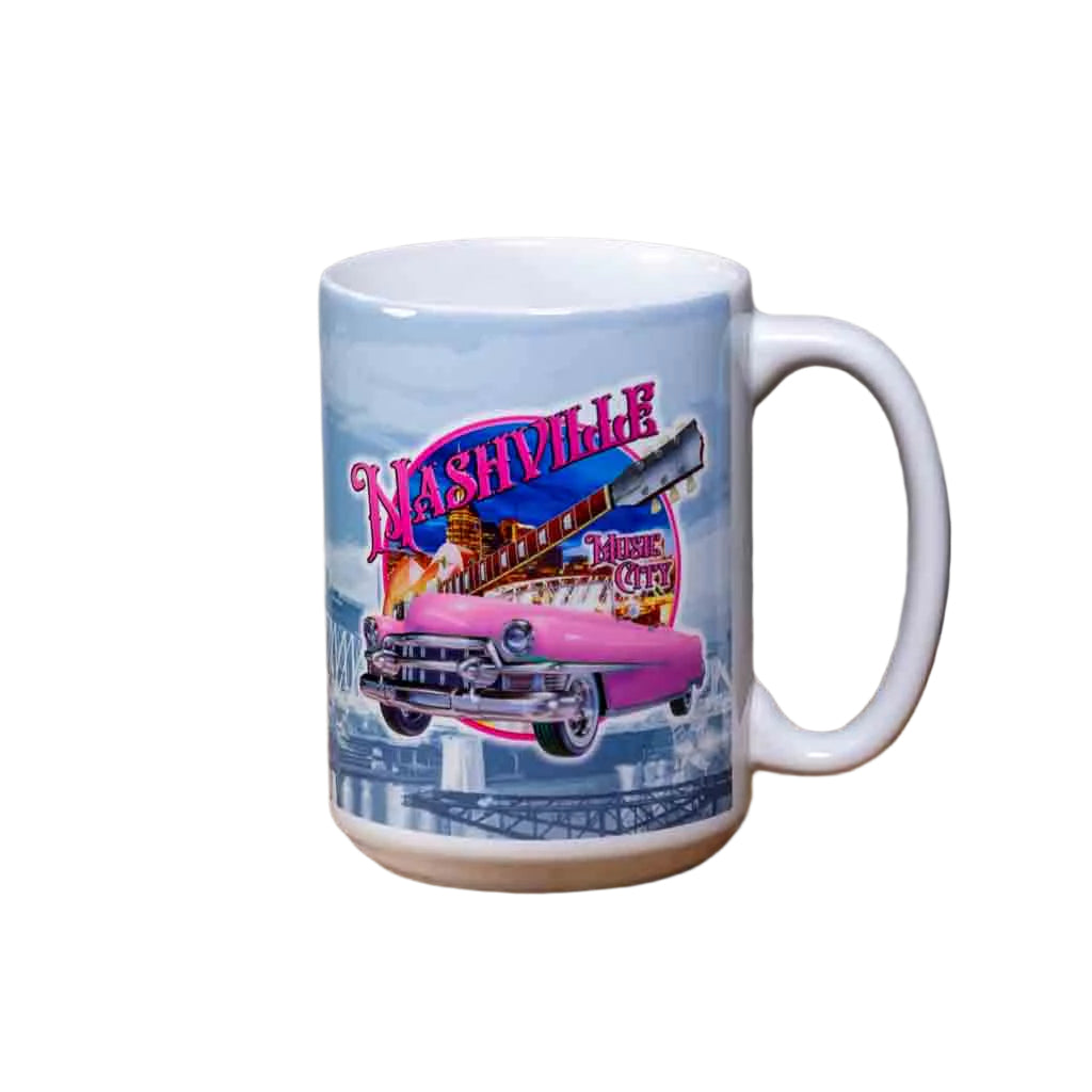 This Pink Cadillac "Nashville Skyline" Coffee Mug is a white ceramic mug with an easy to grip handle. The mug features a wrap around design highlighted by a pink Cadillac and the skyline of downtown Nashville.