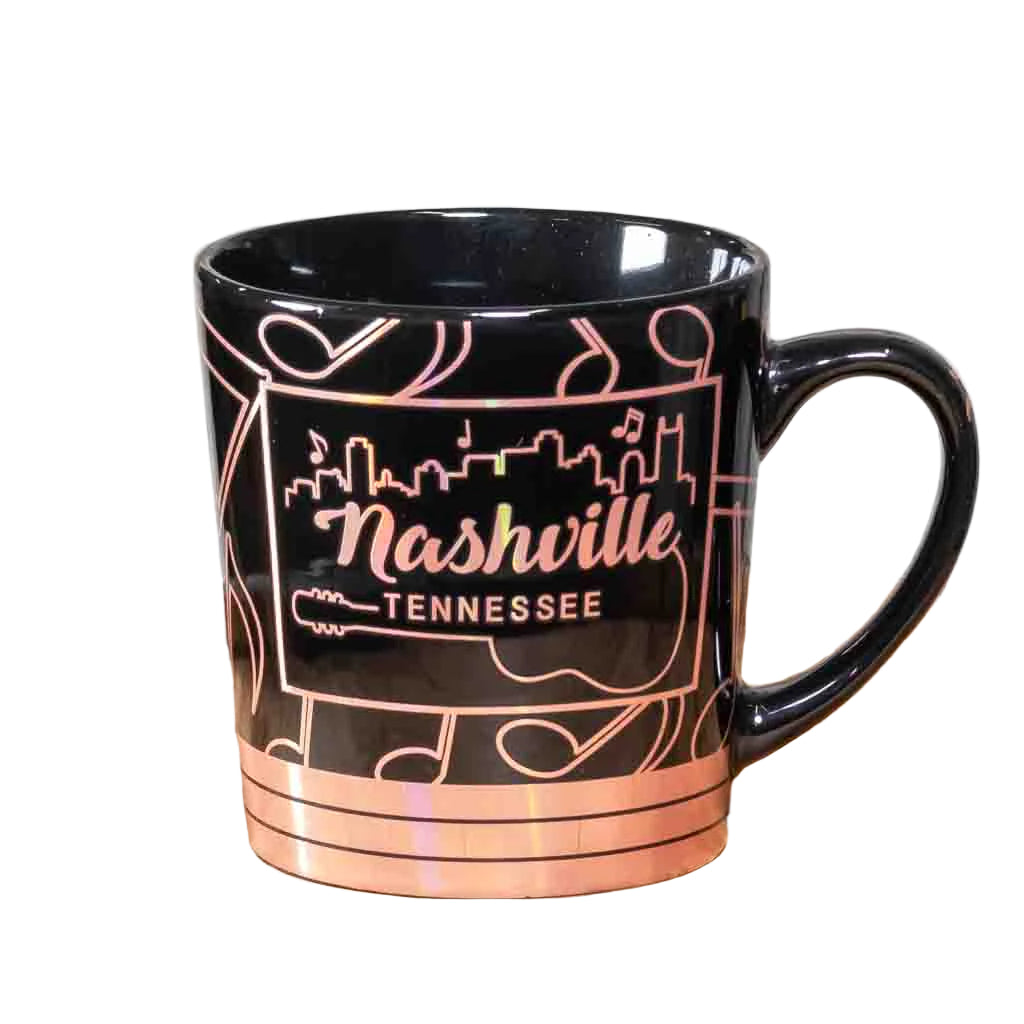 This oversize Nashville Music Notes Coffee Mug has an easy to grip handle and is made from a glossy black ceramic material. The wide mouth mug features a wrap around design of gold reflective music notes along with the Nashville skyline.