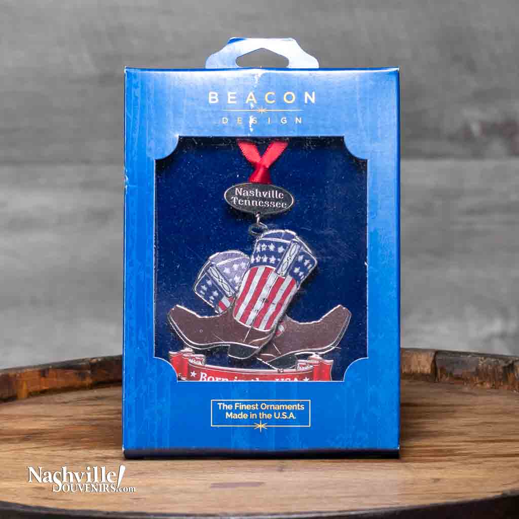 Our new Nashville "Patriotic Cowboy Boots" Collectible Ornament will let you flaunt that you are proud to be an American! It features a beautiful pair of American flag inspired cowboy boots with a banner underneath reading, "Born in the USA". The boots are hanging from a gold banner etched with "Nashville Tennessee".