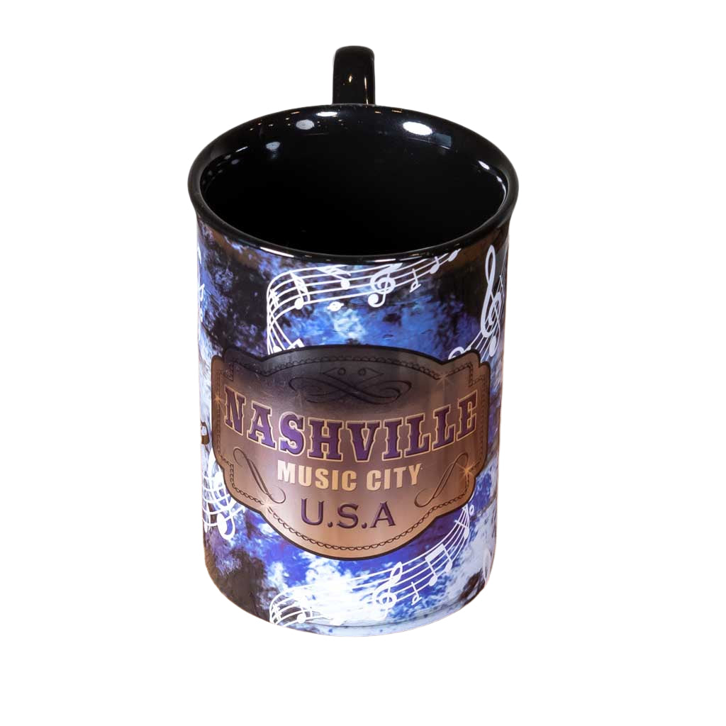 Side view of a great new Nashville Music City USA Mug design that is big and easy to grip. The handle features a large handle with a music note design.  The body of the mug has an intricate design featuring music notes, cowboy boots and guitars.