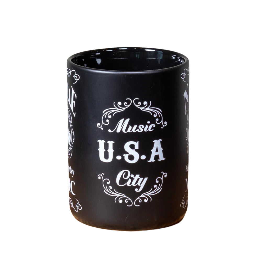 Center view of a great new Nashville "Home of Country Music" Mug design that is big and easy to grip. This mug design features a prominent Nashville with crossed guitars and "Home of Country Music" below. The white on black design is inspired by our famous Tennessee Whiskey.
