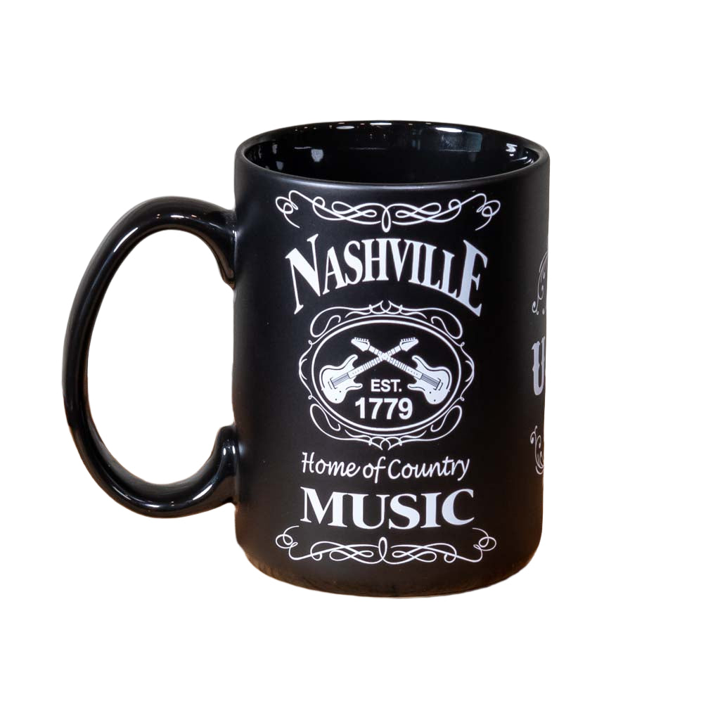 Left side view of a great new Nashville "Home of Country Music" Mug design that is big and easy to grip. This mug design features a prominent Nashville with crossed guitars and "Home of Country Music" below. The white on black design is inspired by our famous Tennessee Whiskey.