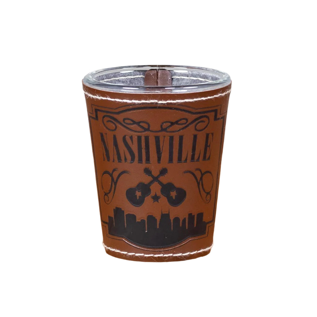 This Nashville Leathered and Stitched Shot Glass features a full wrap leather looking and stitched cover with embossed Nashville above a pair of crossed guitars.bold Nashville logo with guitar and the bottom glass reflects many different colors.
