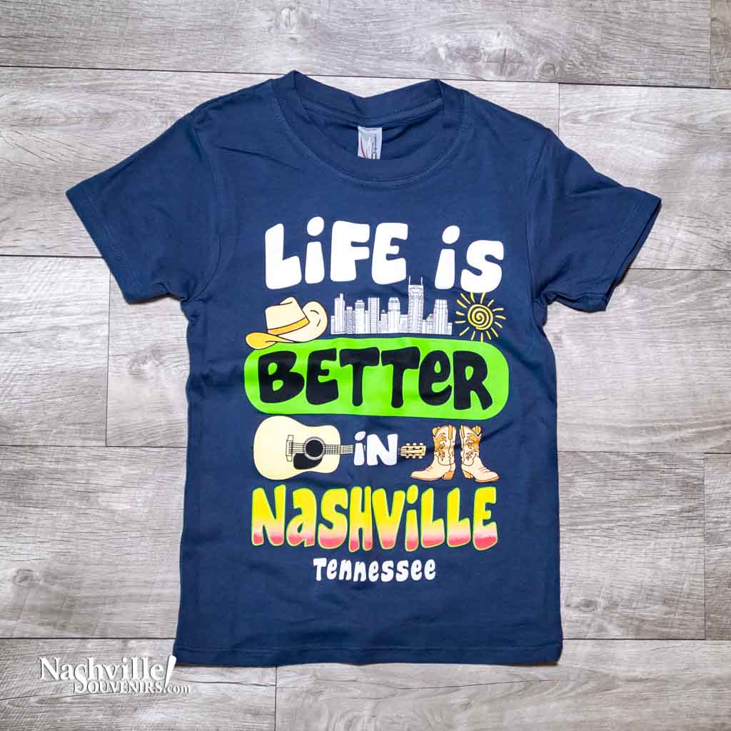 Our new design toddler "Life is Better in Nashville Tennessee" T-Shirt features a colorful logo that includes the Nashville downtown skyline along with a cowboy hat, guitar and boots.  This shirt is available in either Black or Marine Blue and comes in toddlers sizes X-Small, Small, Medium and Large.