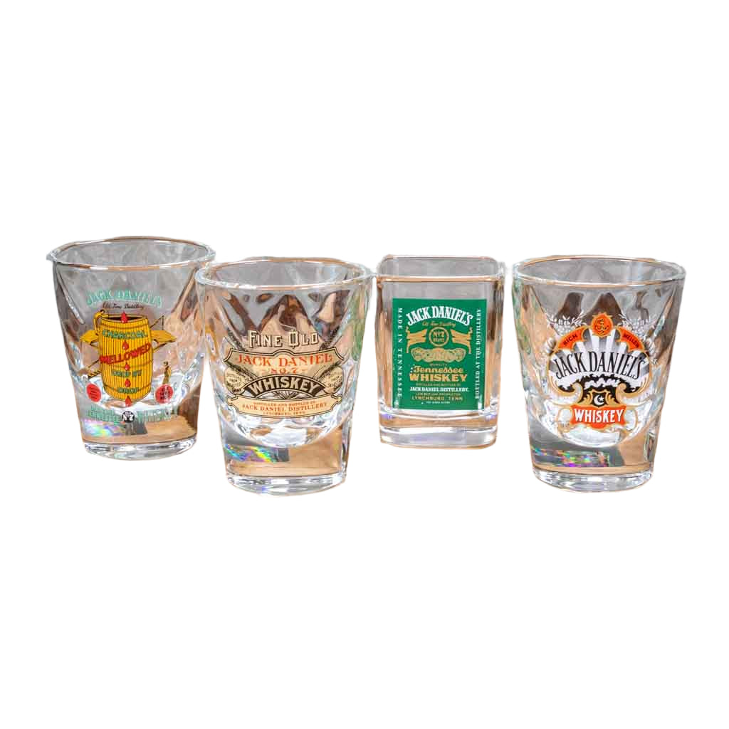 A set of four vintage collectible JacK Daniel shot glasses. Four different vintage JD logos including, the Charcoal Mellowed, Fine Old Whiskey, Green Label and Spade designs.