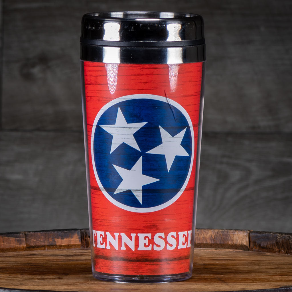A travel mug emblazoned with the TN Tri-Star logo.