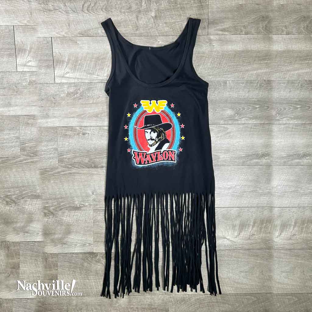 This is a new Waylon Jennings fringe tank top. The shirt has a portrait of Waylon with the flying W above it and the word "Waylon" below it. The long fringe hangs from the waist down. 
