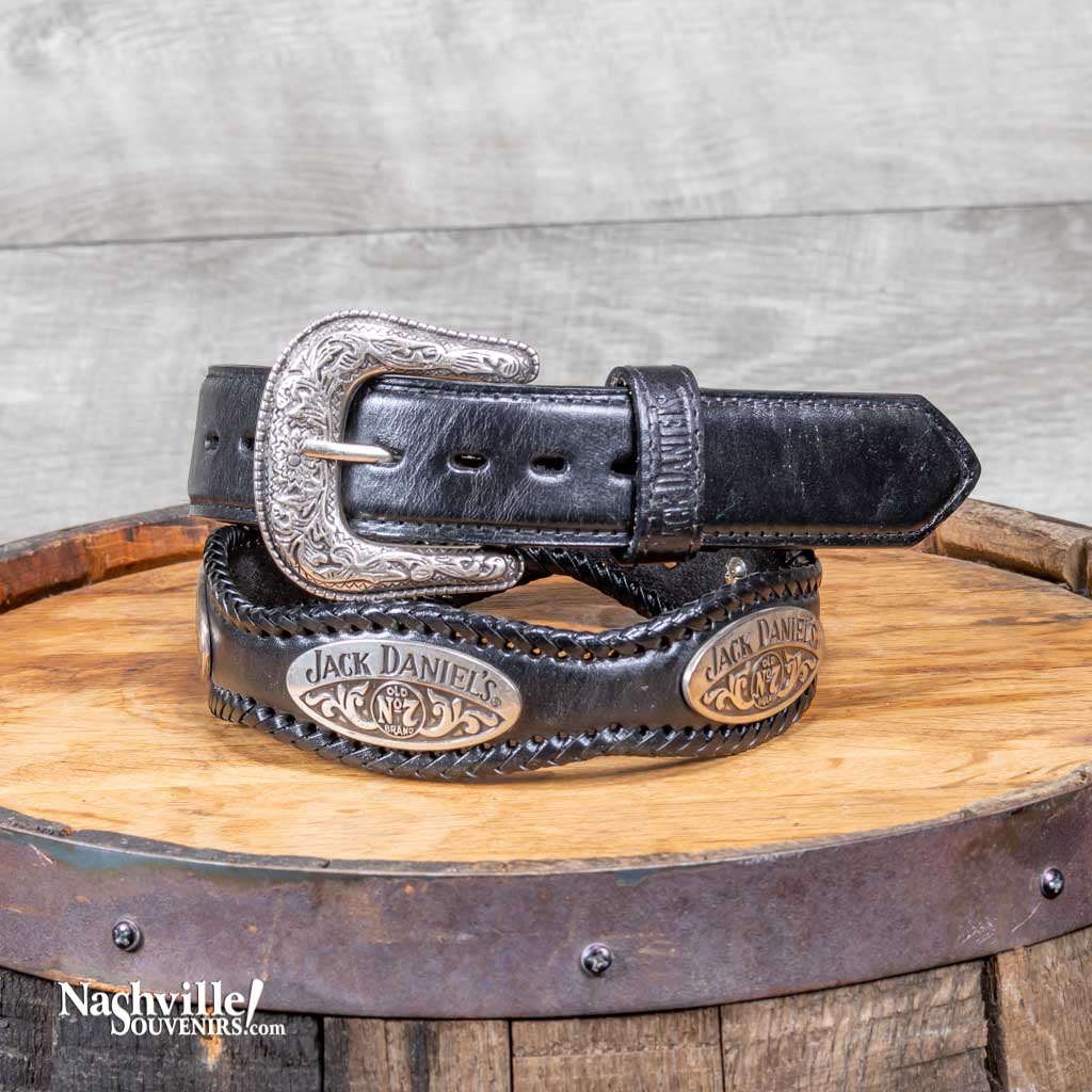 Black version of the officially licensed Jack Daniels Scalloped Belt with JD Conchos is a scalloped leather belt with hand laced edges.  This JD belt features a silver plated buckle and exclusive Jack Daniel's branded conchos around the full width of the belt. 