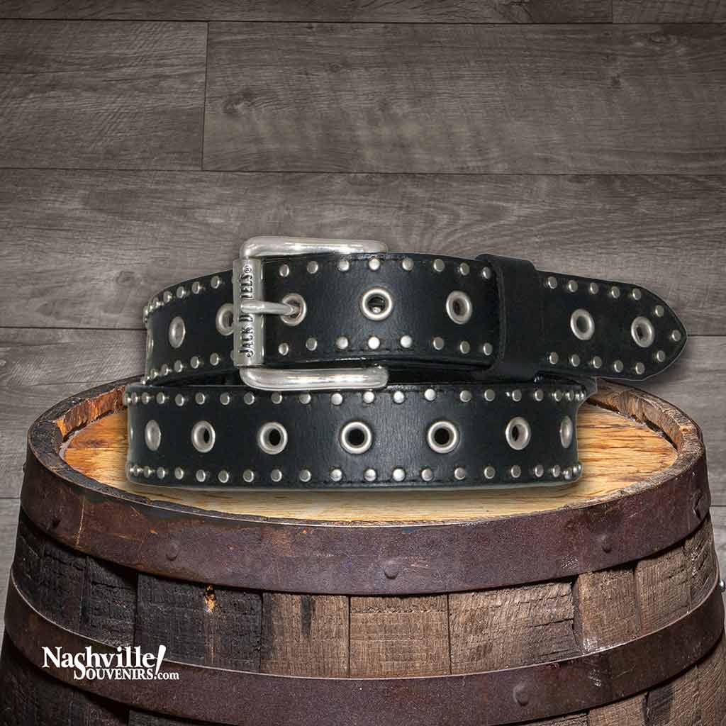 Jack Daniel's belt made from 1 1/2" full grain leather in black and features silver grommets around the upper and lower borders of the strap.