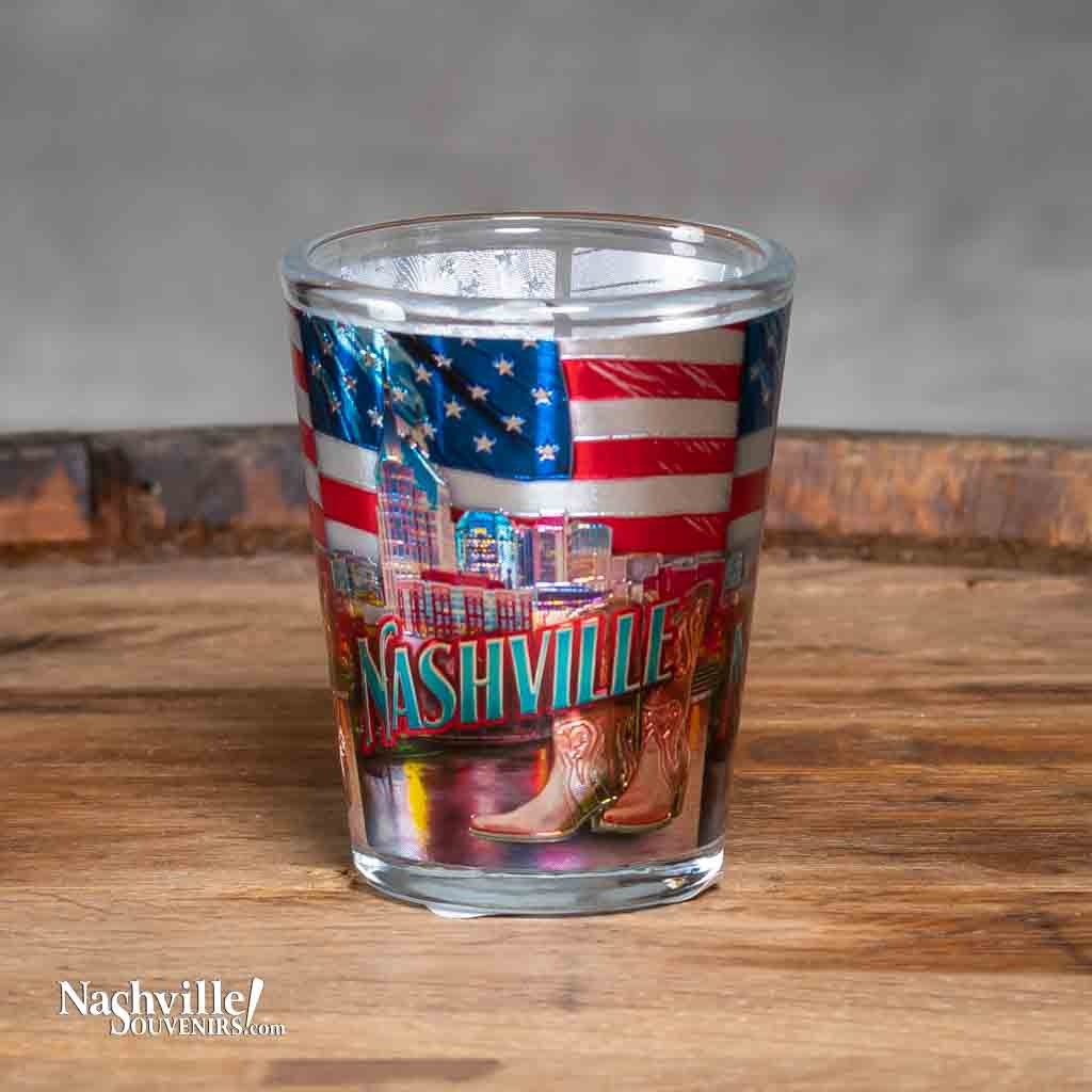 A new design Nashville Skyline and Flag Shot Glass printed with a colorful and scenic background of Nashville, TN with the American flag above.