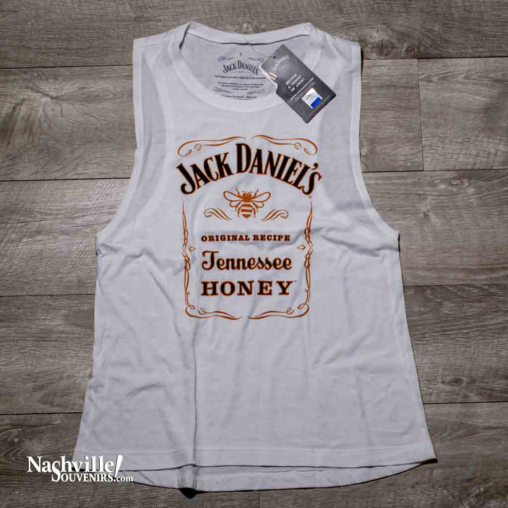 This officially licensed ladies white Jack Daniels Tennessee Honey Tank Top featuring the Tennessee Honey and gold Bee Logo.  This is a beautiful ladies white tank top with the Jack Daniels Tennessee Honey logo printed in a light creme colored font that contrasts very nicely with the iconic gold bee in the center. 