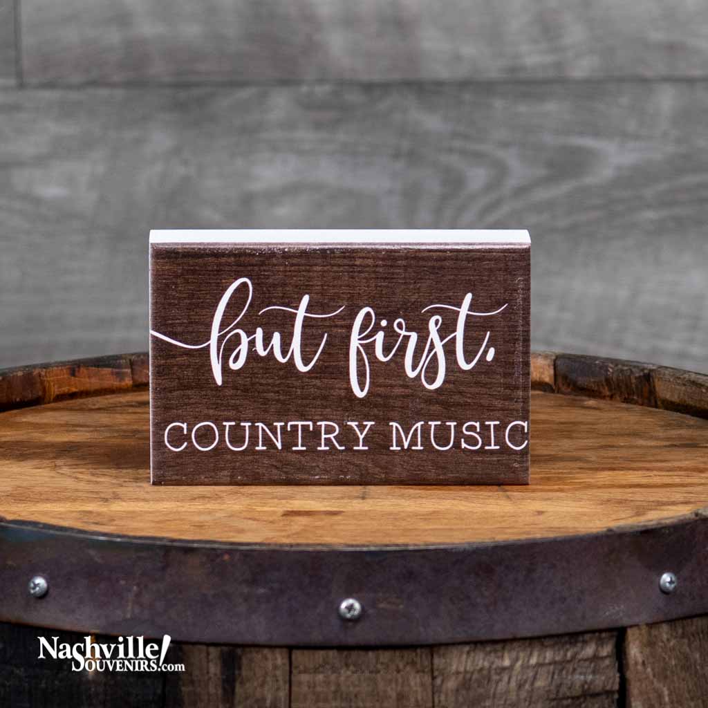 A simple sign that says it all, "But first, Country Music" Wood Sign. It features a great saying in white lettering against a dark brown background.  This free standing solid wood sign is 3 1/4" tall by 5 1/4" wide.