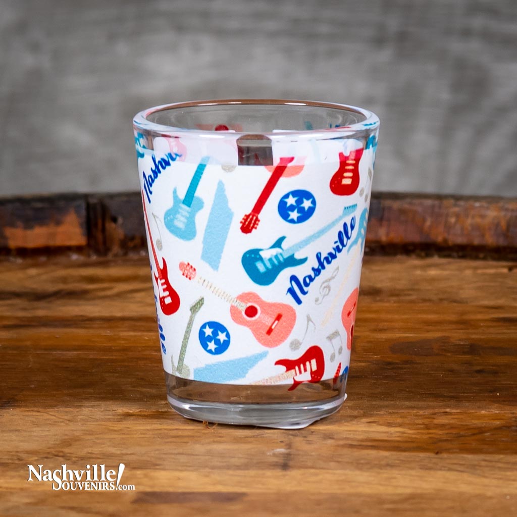 This Nashville Guitars Shot Glass features a full wrap image that includes multiple guitars and the words Nashville.