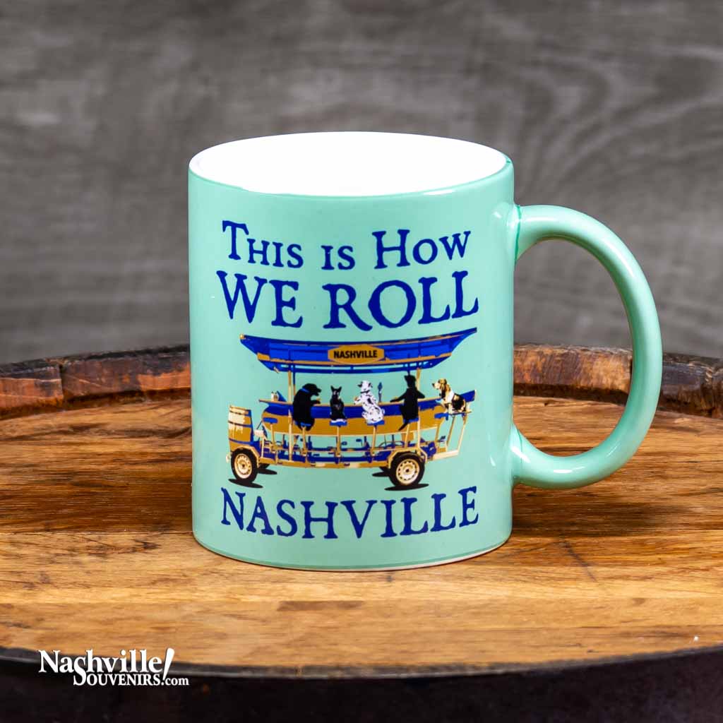 This "How We Roll in Nashville" coffee mug features a full wrap image that pays homage to the ever popular downtown Nashville pedal taverns.