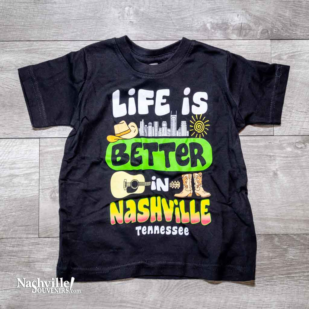 Our new design toddler "Life is Better in Nashville Tennessee" T-Shirt features a colorful logo that includes the Nashville downtown skyline along with a cowboy hat, guitar and boots.  This shirt is available in either Black or Royal Blue and comes in toddlers sizes 2T, 3T and 4T.