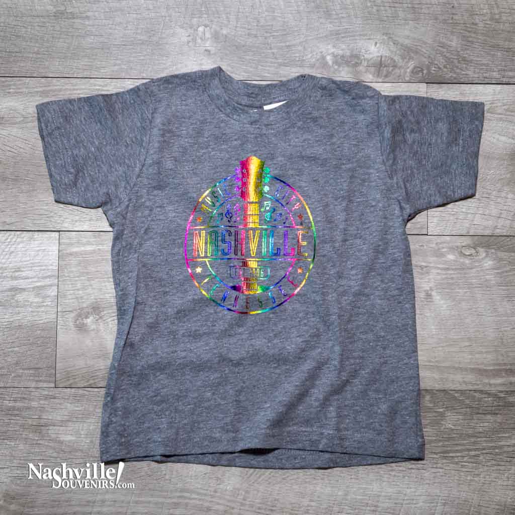 Our new design toddler "Music City Nashville" T-Shirt features a colorful, reflective  logo that includes a multicolor guitar surrounded by music notes.  This shirt is available in either Navy or Granite and comes in toddlers sizes 2T, 3T and 4T.