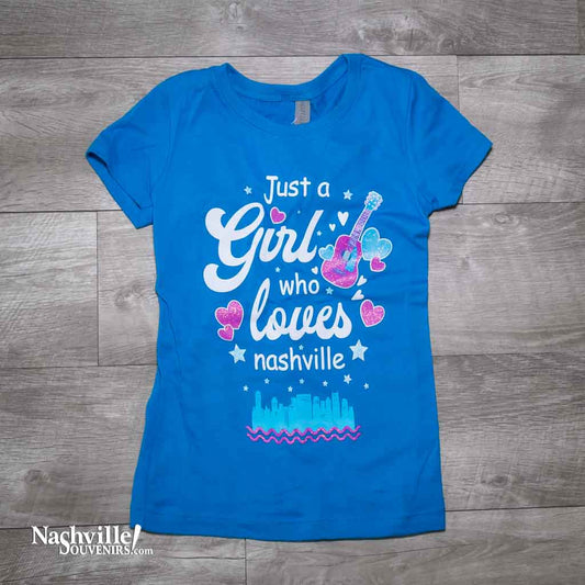 Our new design "Just A Girl Who Loves Nashville" T-Shirt features a colorful logo that includes the Nashville downtown skyline and guitar and hearts.  This shirt is available in either Turquoise or Silk and comes in youth sizes X-Small, Small, Medium and Large.