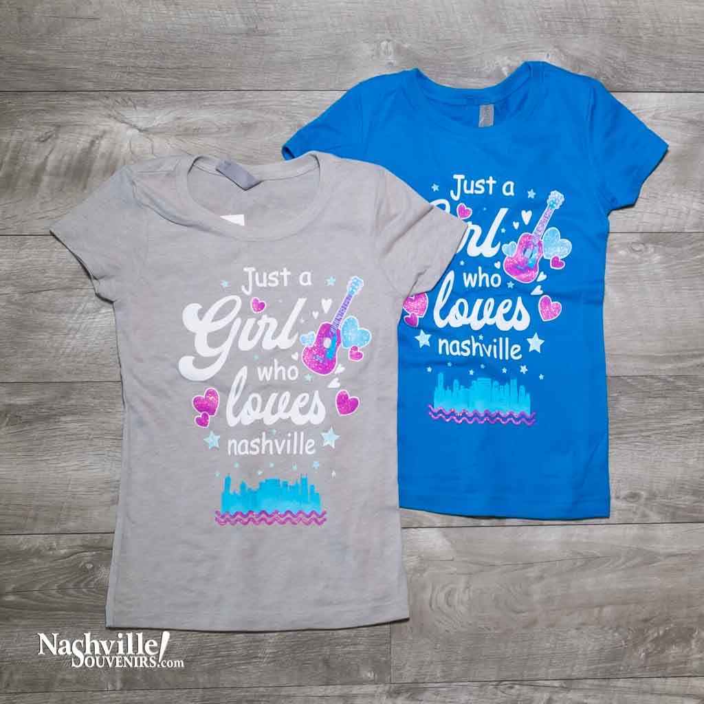 Our new design "Just A Girl Who Loves Nashville" T-Shirt features a colorful logo that includes the Nashville downtown skyline and guitar and hearts.  This shirt is available in either Turquoise or Silk and comes in youth sizes X-Small, Small, Medium and Large.