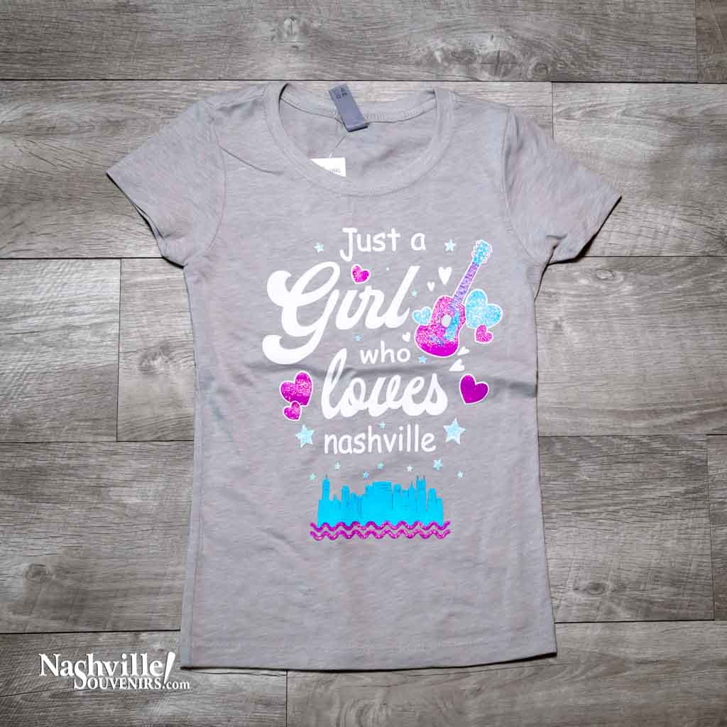Our new design "Just A Girl Who Loves Nashville" T-Shirt features a colorful logo that includes the Nashville downtown skyline and guitar and hearts.  This shirt is available in either Turquoise or Silk and comes in youth sizes X-Small, Small, Medium and Large.