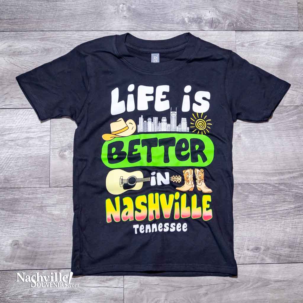 Our new design toddler "Life is Better in Nashville Tennessee" T-Shirt features a colorful logo that includes the Nashville downtown skyline along with a cowboy hat, guitar and boots.  This shirt is available in either Black or Marine Blue and comes in toddlers sizes X-Small, Small, Medium and Large.