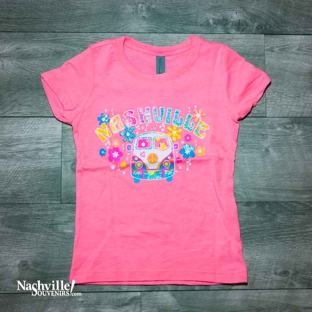 Our new design, youth "Flower Child Bus Nashville" T-Shirt features a colorful, glittery logo Nashville atop the front of an iconic VW love bus popular during the 70's.  This shirt is available in either Pink or Black and comes in youth sizes X-Small, Small, Medium and Large.