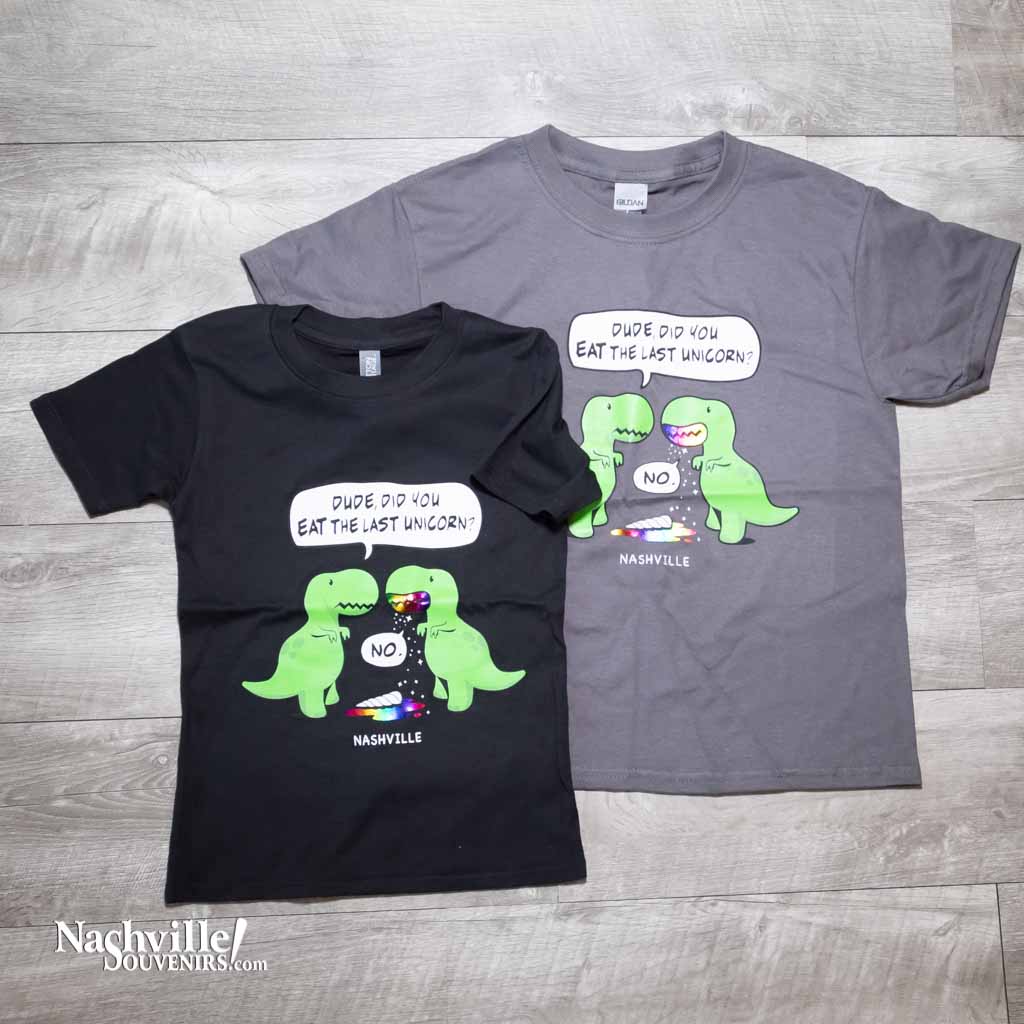 Black and Charcoal gray kids youth "Last Unicorn Nashville" T-Shirt features a colorful logo that includes two dinosaurs discussing the mysterious demise of the last unicorn! Beneath the dinosaurs you'll find "Nashville"
