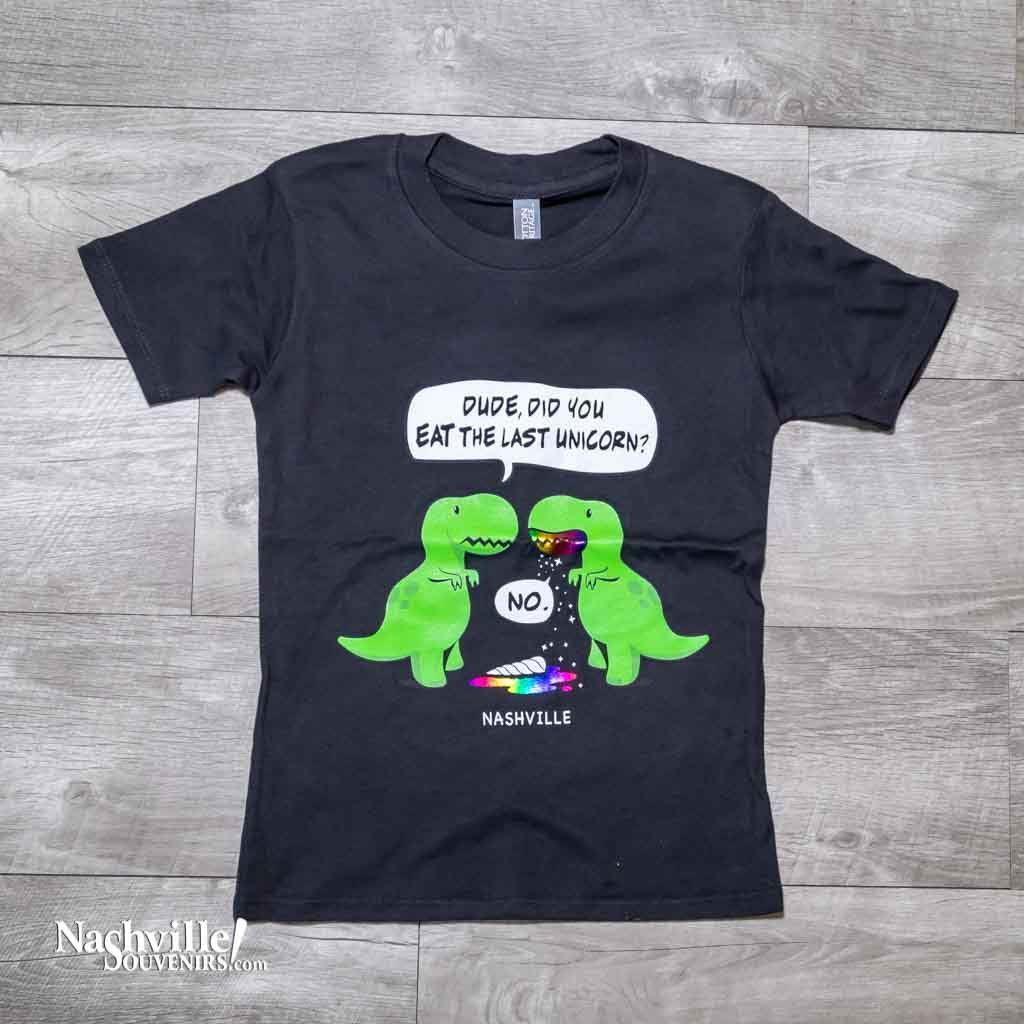 Black kids youth "Last Unicorn Nashville" T-Shirt features a colorful logo that includes two dinosaurs discussing the mysterious demise of the last unicorn! Beneath the dinosaurs you'll find "Nashville"