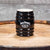 This collectible Jack Daniel's Black Barrel Stoneware Shot Glass is a new design for 2022 from Jack Daniel's. It features the famous Jack Daniel's Swing and Cartouche logo.  It is a 2.5 oz stoneware JD shot glass that has been crafted to resemble their iconic whiskey barrels housed in the famous Lynchburg, TN barrel houses. The shot glass is 3" tall.