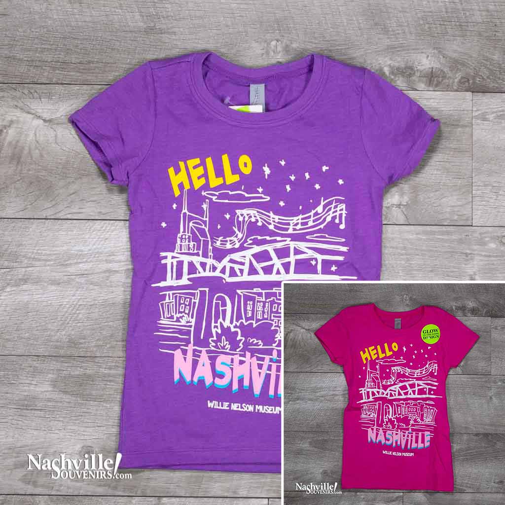 kids Hello Nashville Youth T-Shirt features a colorful glow-in-the-dark logo with the Nashville skyline and Willie Nelson Museum at the bottom of the t-shirt.